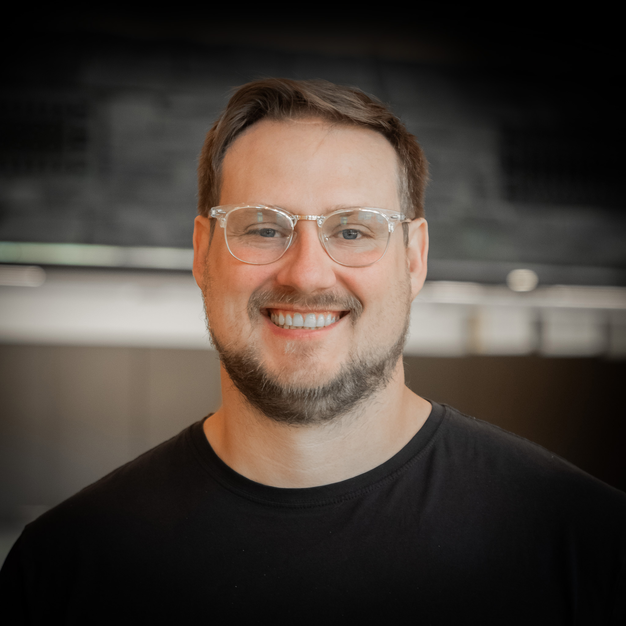 man with glasses and grey shirt