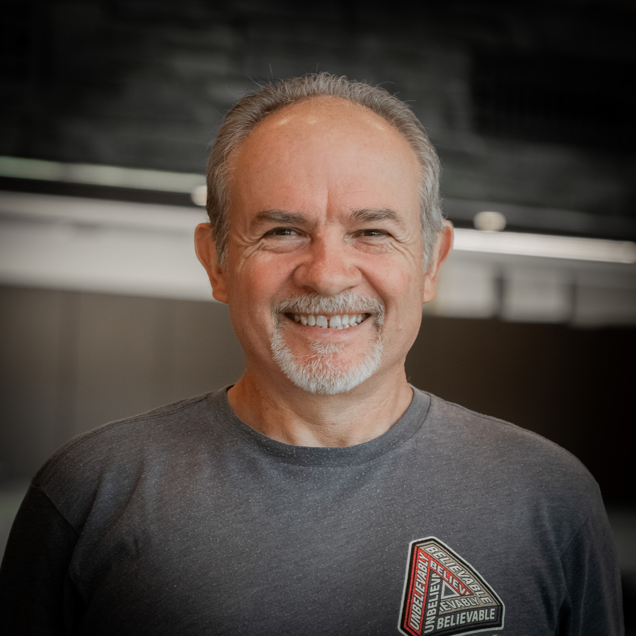 man smiling with wearing a camp shirt