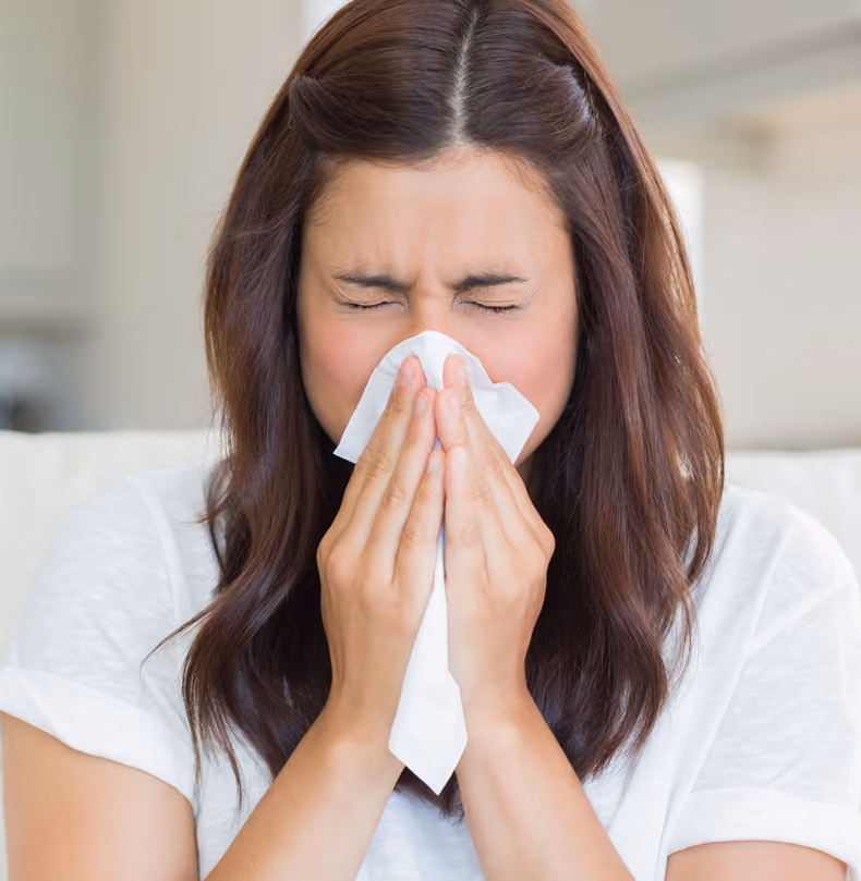 woman blowing nose
