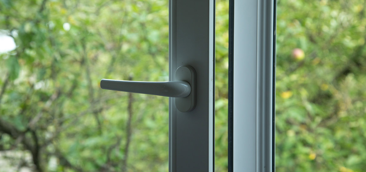 A burglar pries open a window.