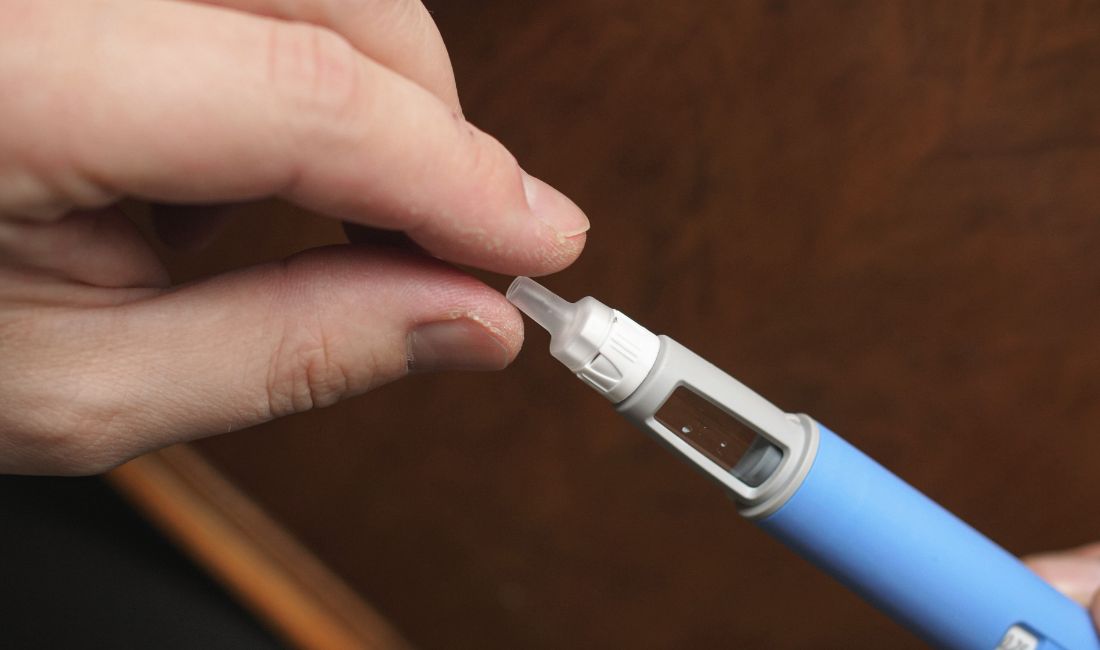 A Person's Hand Holding a Ozempic Injection Tube