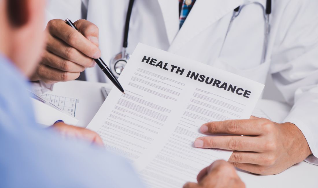 A Person Being Presented With a Health Insurance Document By a Health Care Professional