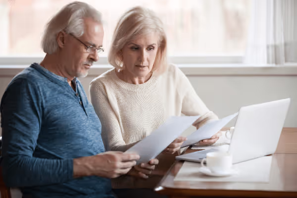 senior couple reading life insurance docs