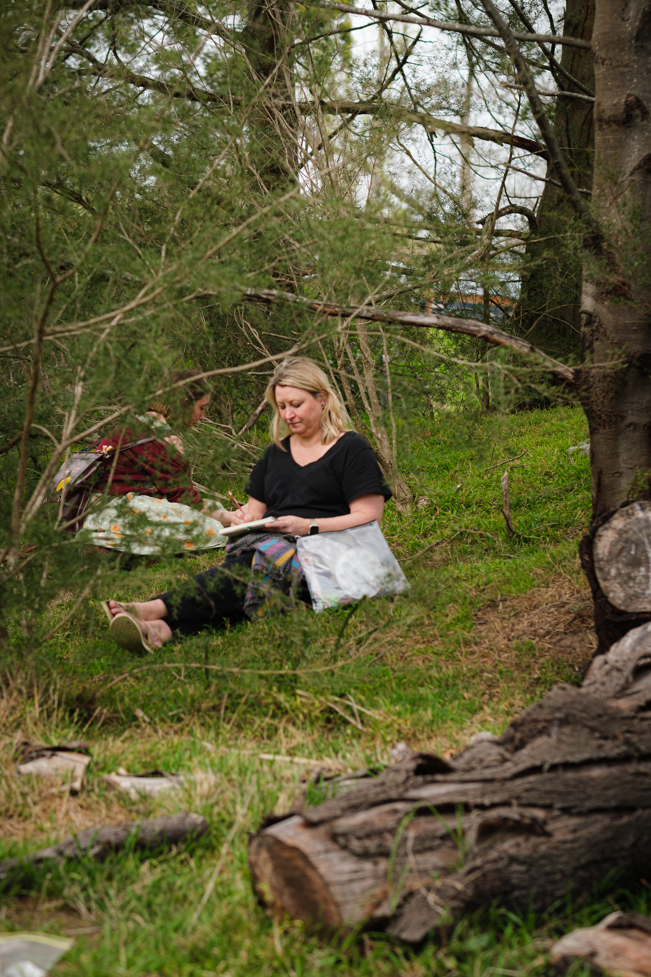 A participant of Wild Wanderings 2025 focused on her sketch