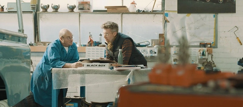 Dave Budge and a teammate refurbishing Land Rovers in the workshop