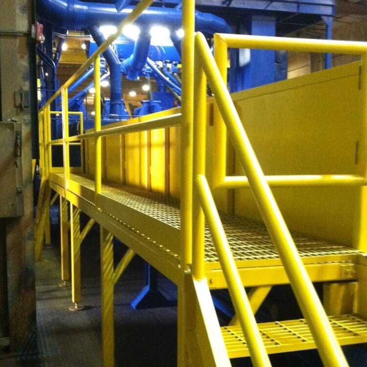 Metal fabricated yellow platform with stairs and railings