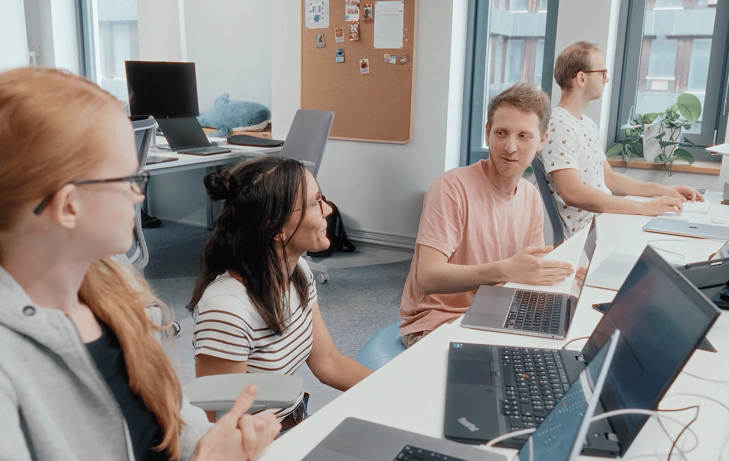 Two people talking and looking at a computer screen