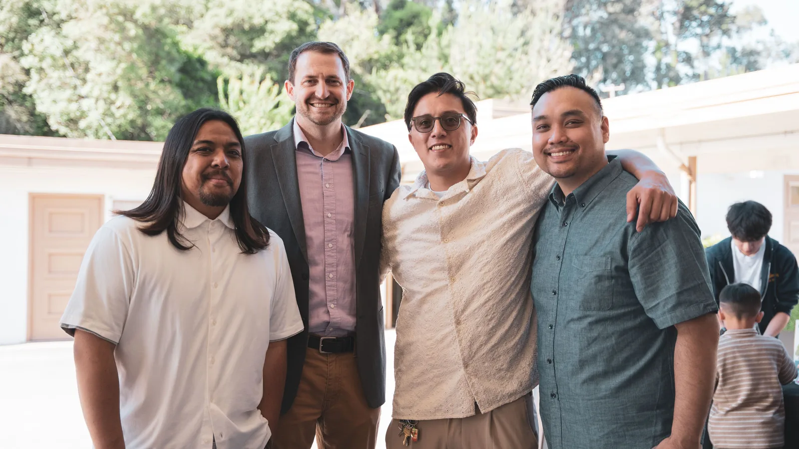Four men smiling together at New North Church