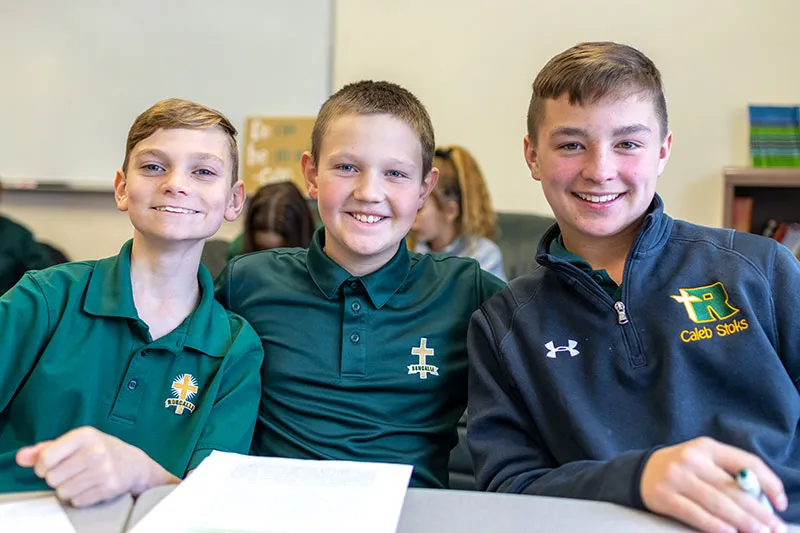 three boy students smiling
