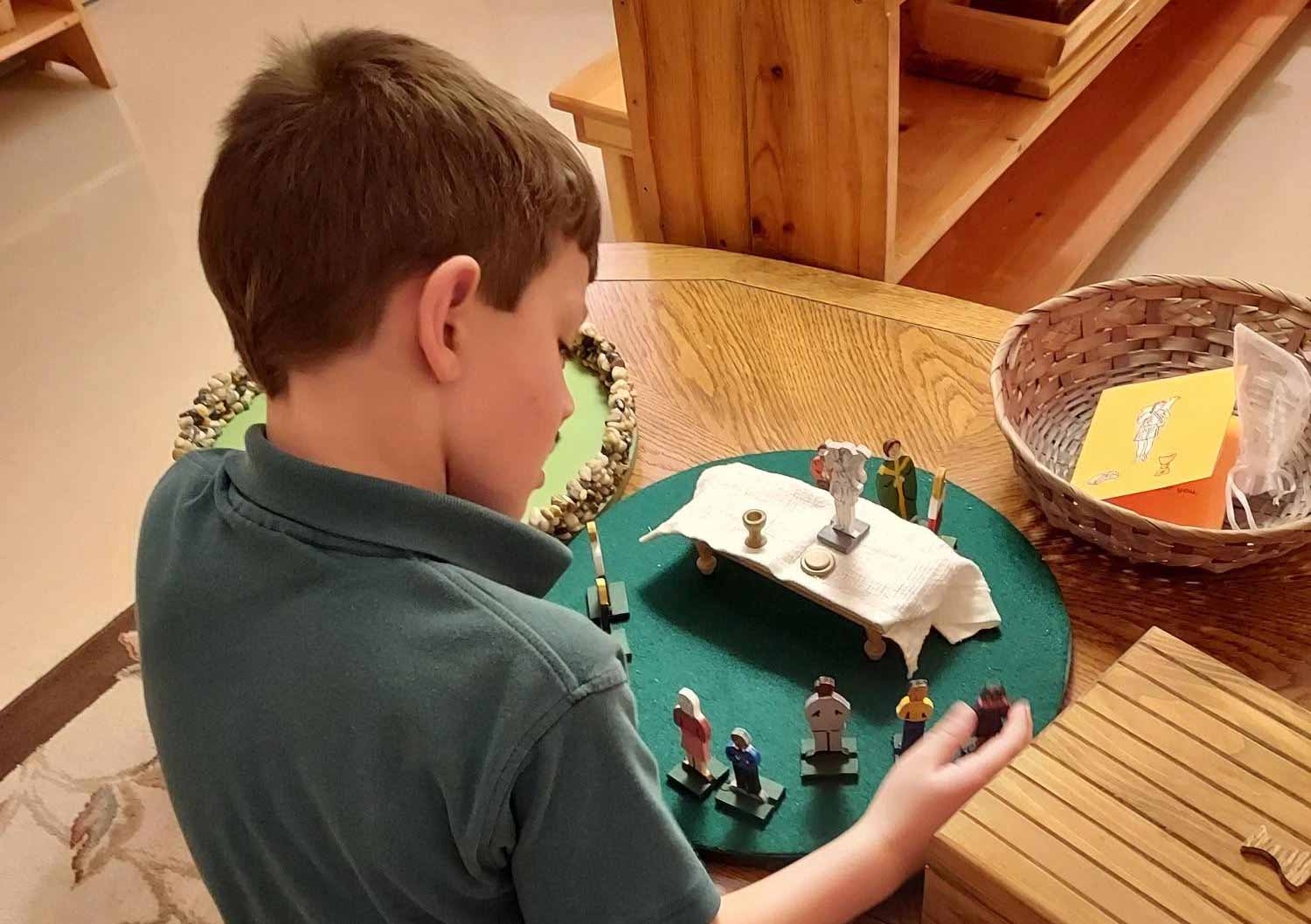 student working with religious figurines