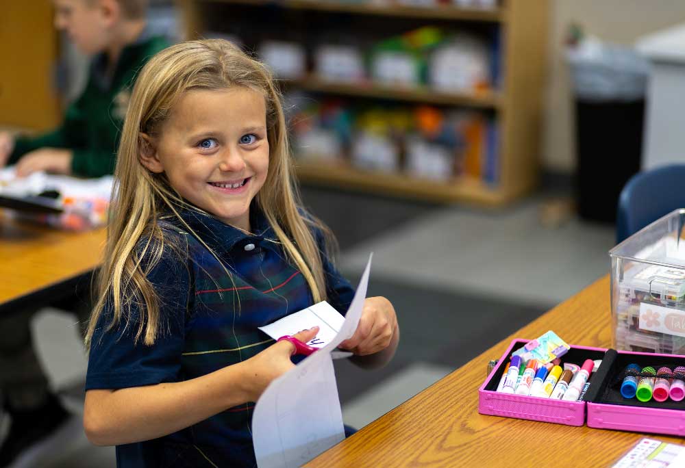 girl student cutting paper