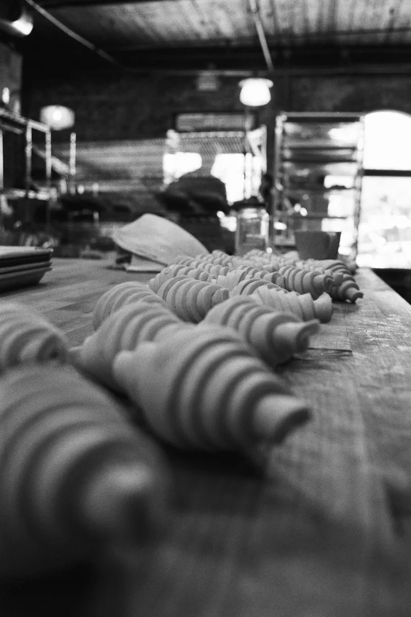 Croissants proving on a bakery bench