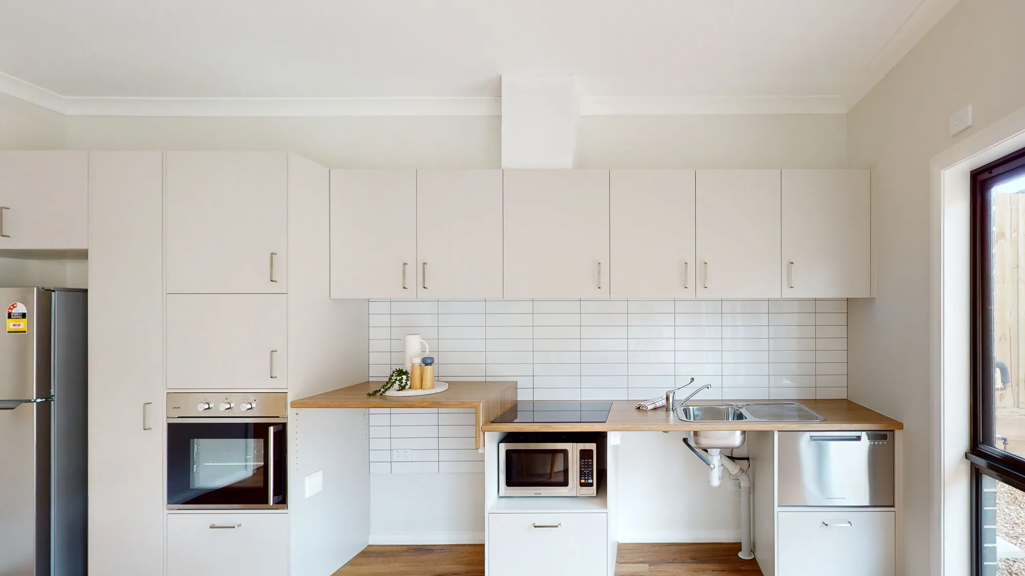 a kitchen with white cabinets and white counter tops