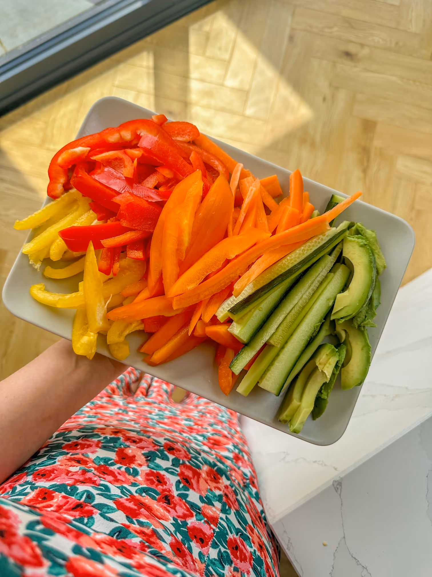 A beautifully arranged plate of Flower Futomaki Sushi Rolls, featuring a central green roll surrounded by colorful petals.