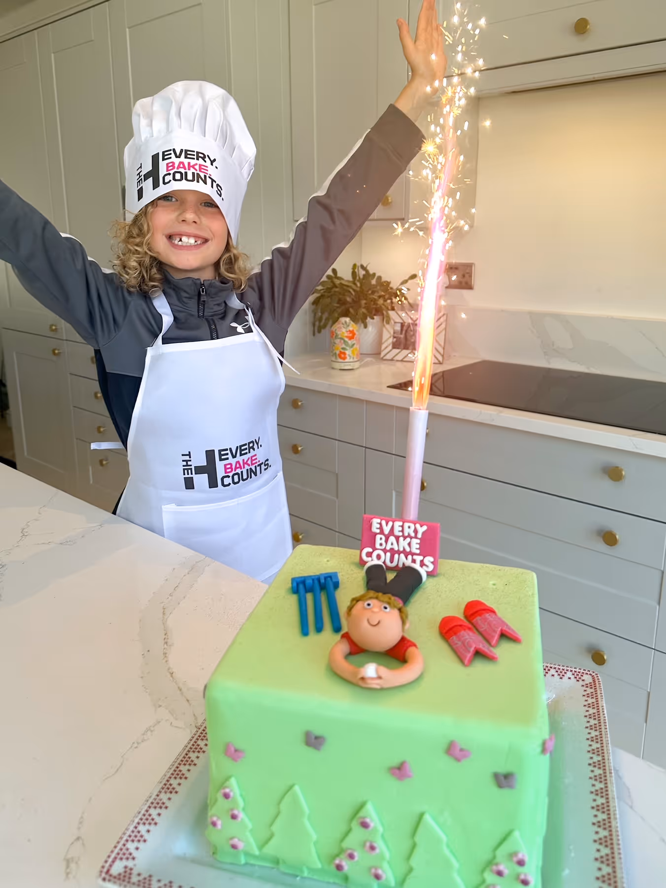 Our family proudly posing with Matty Edgell's Welsh Fire-themed cake, celebrating the Every Bake Counts Challenge.