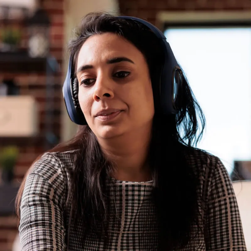 virtual attendee of woman at home wearing headphones