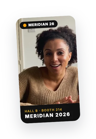 A conference attendee's video testimonial with a Meridian 2026 overlay reading Hall B, Booth 214