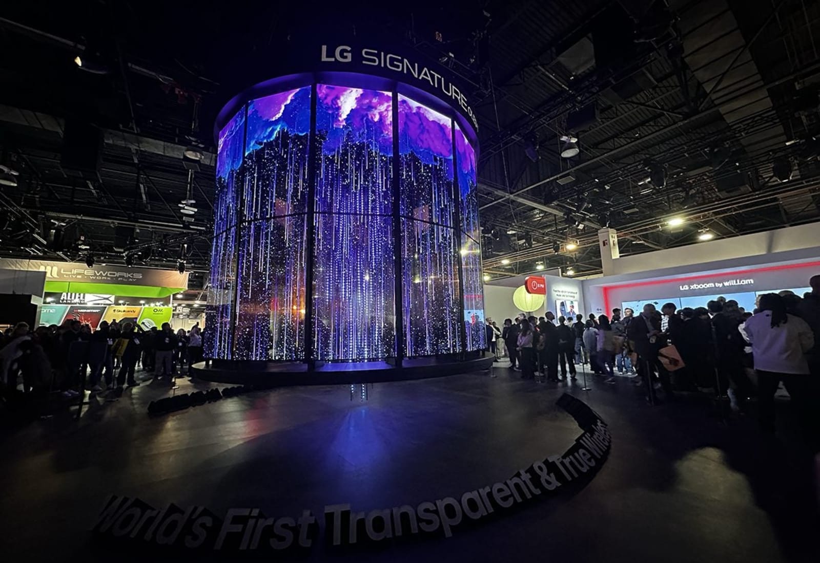 LG CES 2025 booth with transparent OLED display carousel and sustainable corrugated cardboard signage