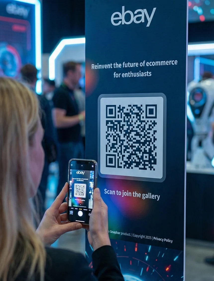Attendee scanning a QR code at a branded booth activation with eBay event signage and digital photo experience