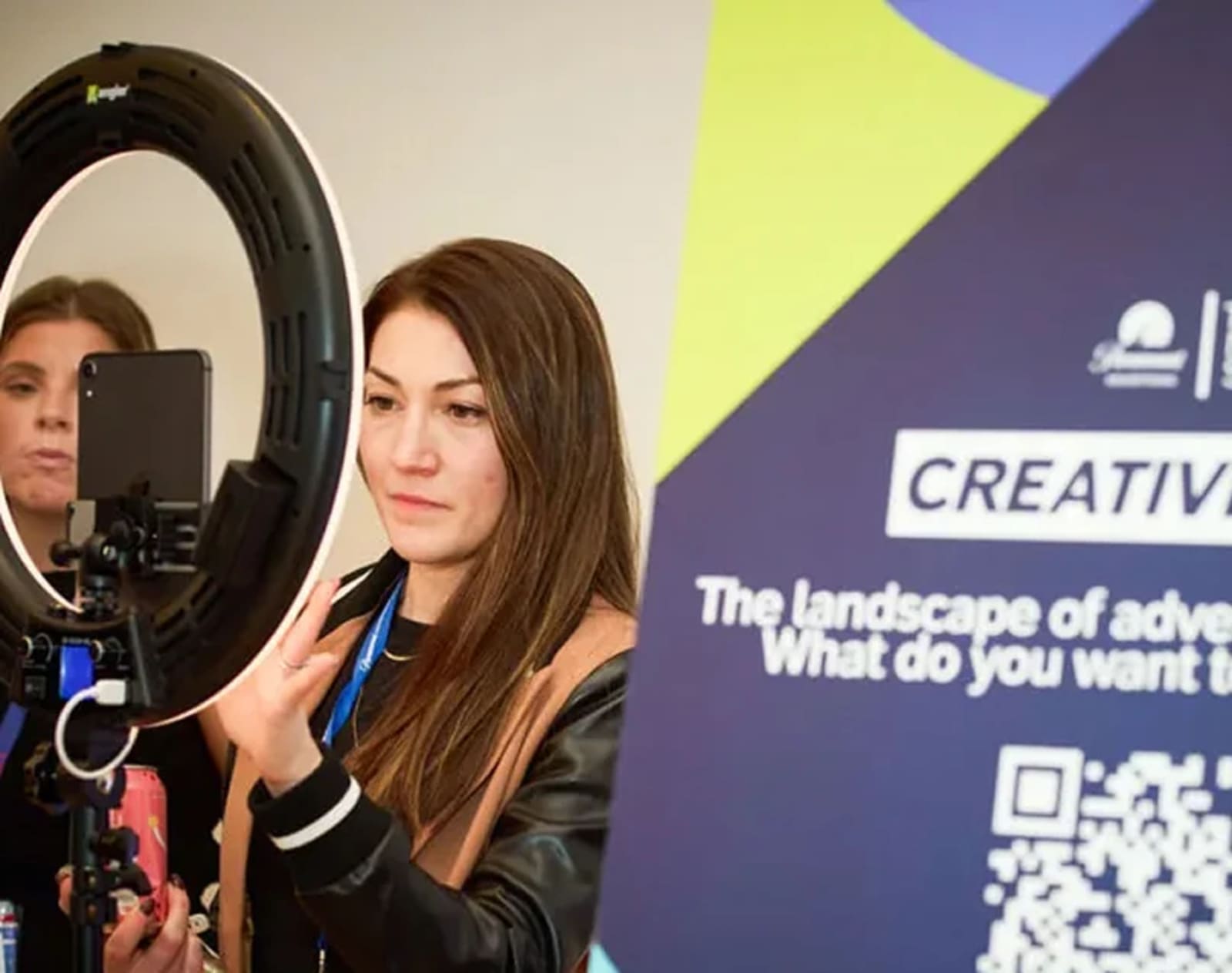 Guest at a branded AI activation selfie station interacting with the on-screen experience at a live event