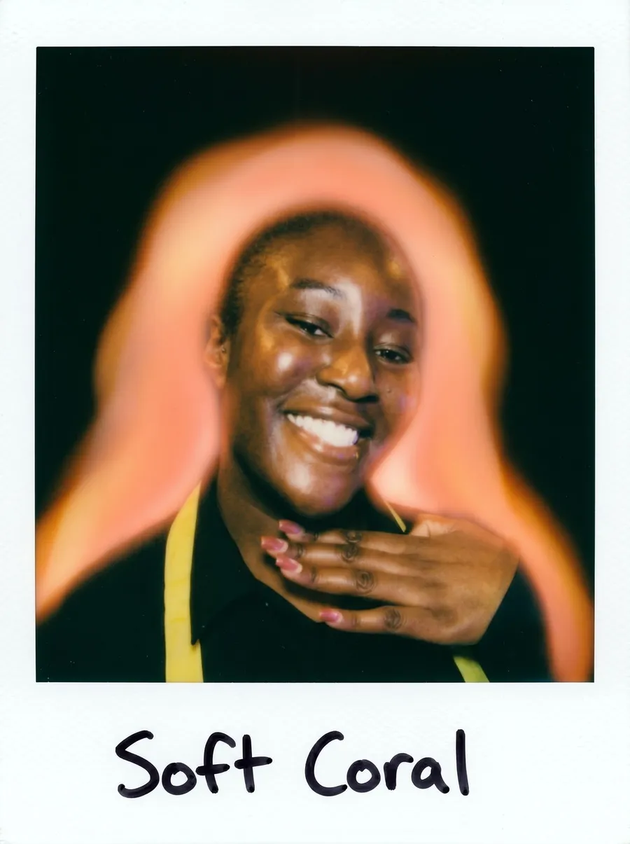 AI photo of a guest smiling in a polaroid-style frame with a soft coral aura, captioned Soft Coral