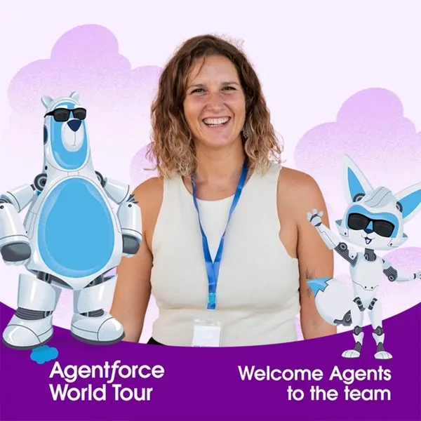 Photo booth snapshot of a guest between robot mascots on a Salesforce Agentforce World Tour frame