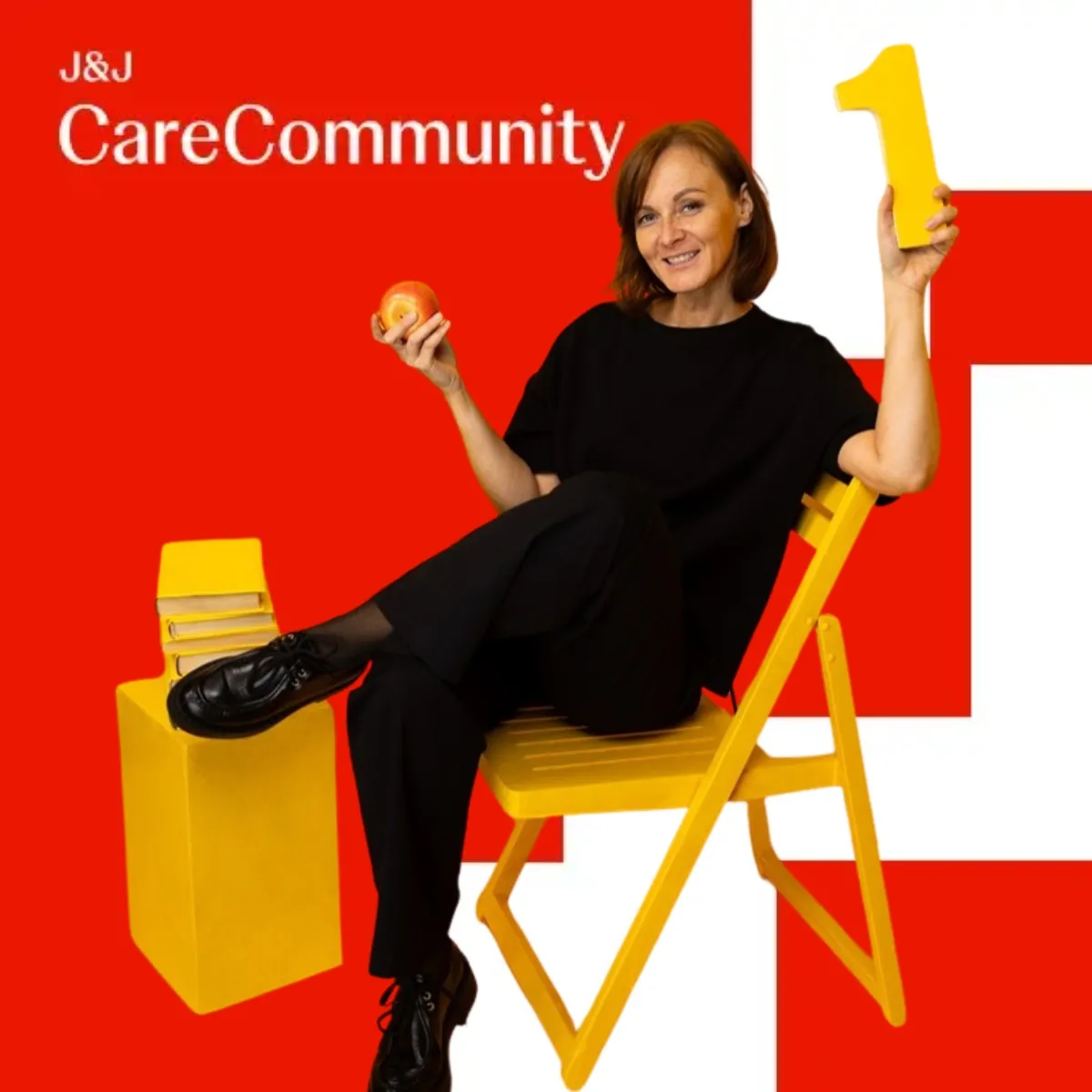 Photo booth snapshot of a guest posing on a yellow chair in a red J&J CareCommunity studio set