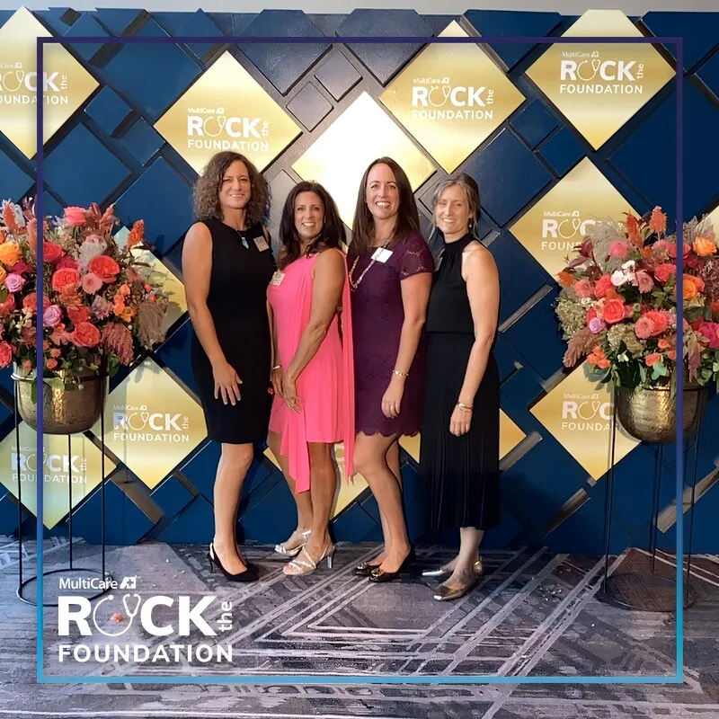 Photo booth snapshot of four guests in evening wear at the MultiCare Rock the Foundation gala