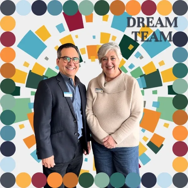 Photo booth snapshot of two colleagues on a colorful mosaic Dream Team frame