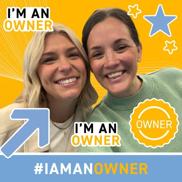 Photo booth snapshot of two guests on a yellow I'm An Owner frame with an owner badge