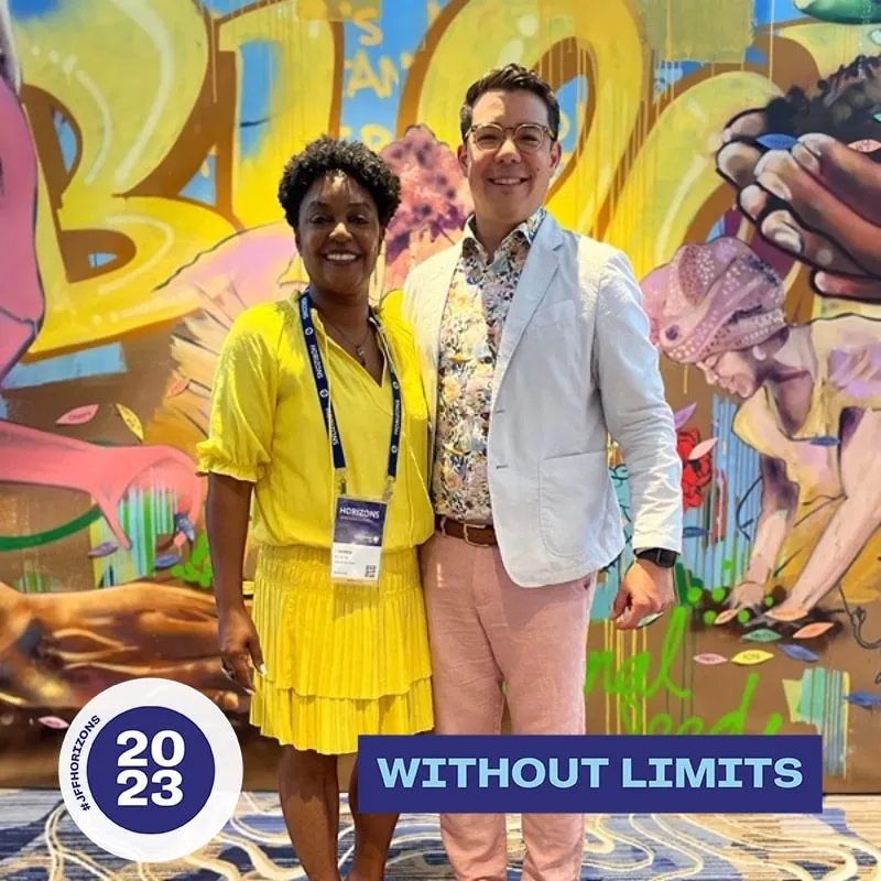 Photo booth snapshot of two guests in front of a mural on a Without Limits 2023 frame