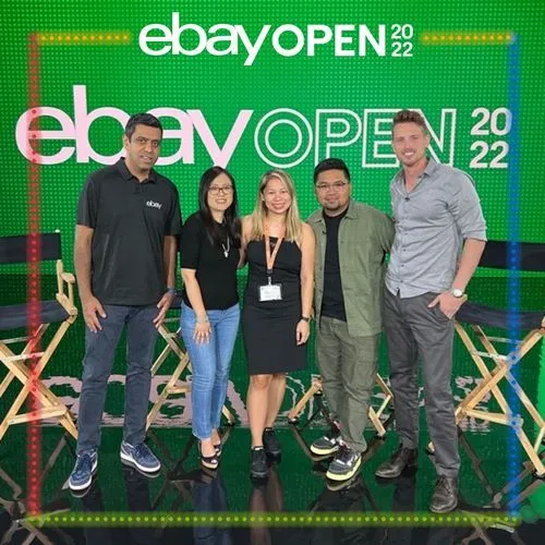 Photo booth snapshot of five teammates on stage chairs on an eBay Open 2022 frame