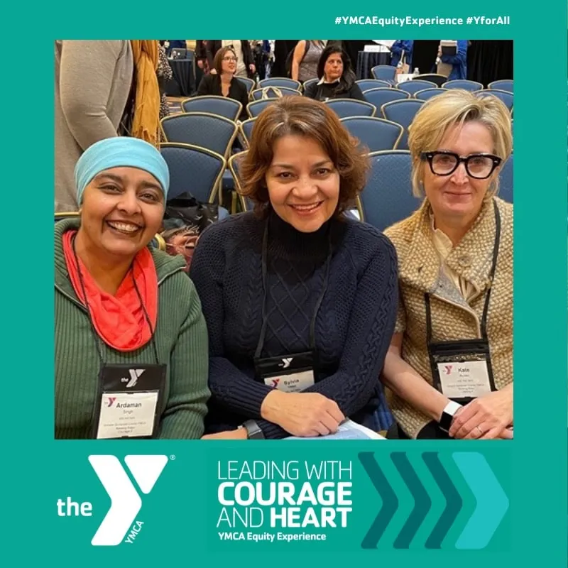 Photo booth snapshot of three guests on a YMCA Leading with Courage and Heart Equity Experience frame