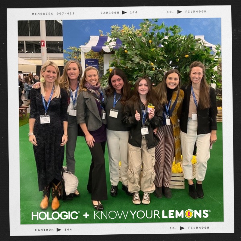 Photo booth snapshot of seven guests on a Hologic and Know Your Lemons frame with a lemon tree backdrop