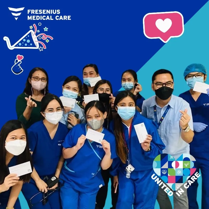 Photo booth snapshot of a team of nurses holding cards on a Fresenius Medical Care United in Care frame