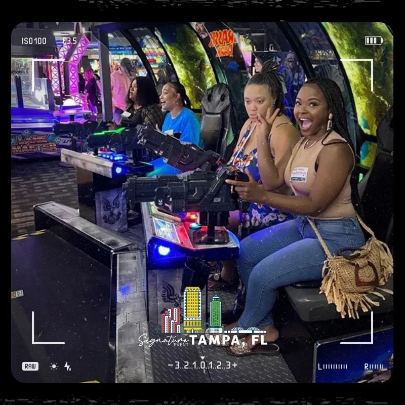 Photo booth snapshot of guests playing arcade racing games on a Signature Tampa film frame