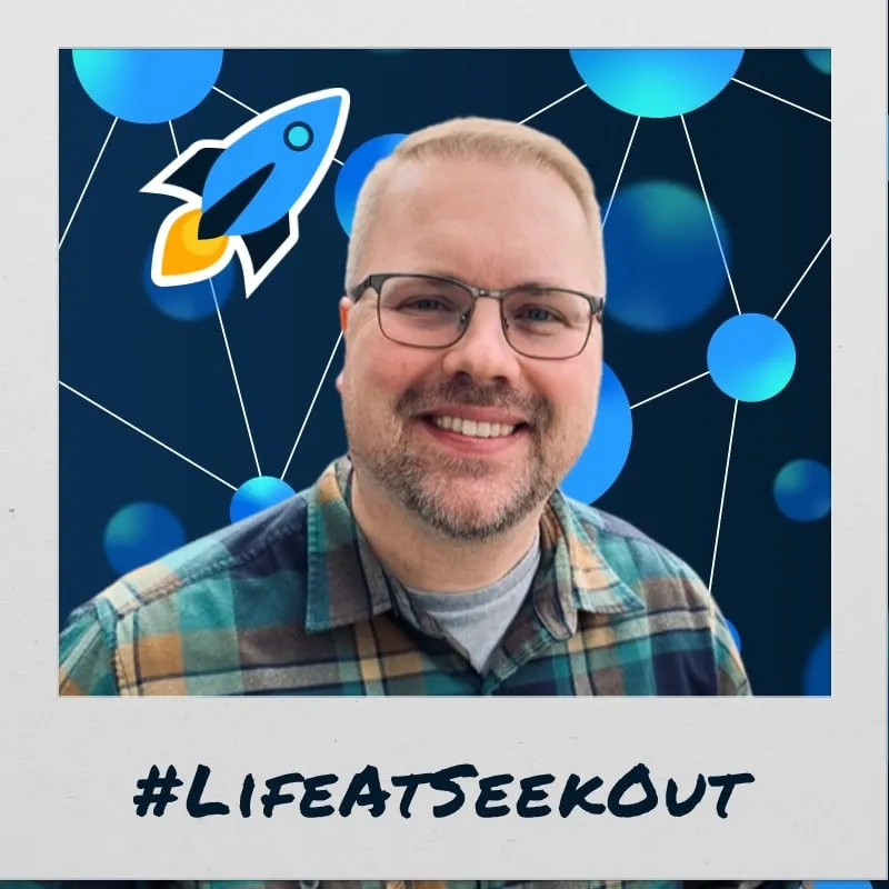 Photo booth snapshot of a guest on a polaroid style Life at SeekOut frame with a rocket sticker