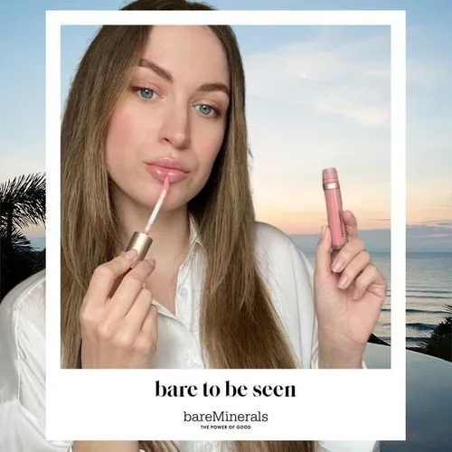 Photo booth snapshot of a guest applying lip gloss on a bareMinerals bare to be seen frame