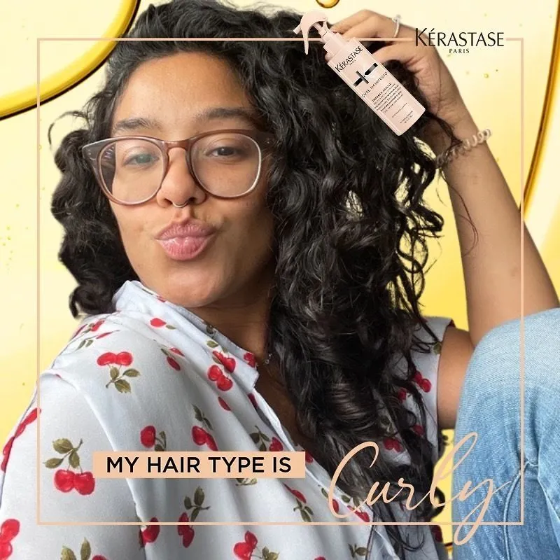 Photo booth snapshot of a guest on a Kerastase My Hair Type Is Curly frame