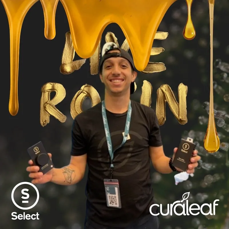Photo booth snapshot of a guest holding products under gold Live Rosin balloons on a Curaleaf Select frame