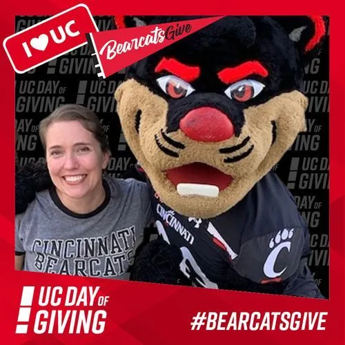Photo booth snapshot of a guest with the Bearcat mascot on a UC Day of Giving frame