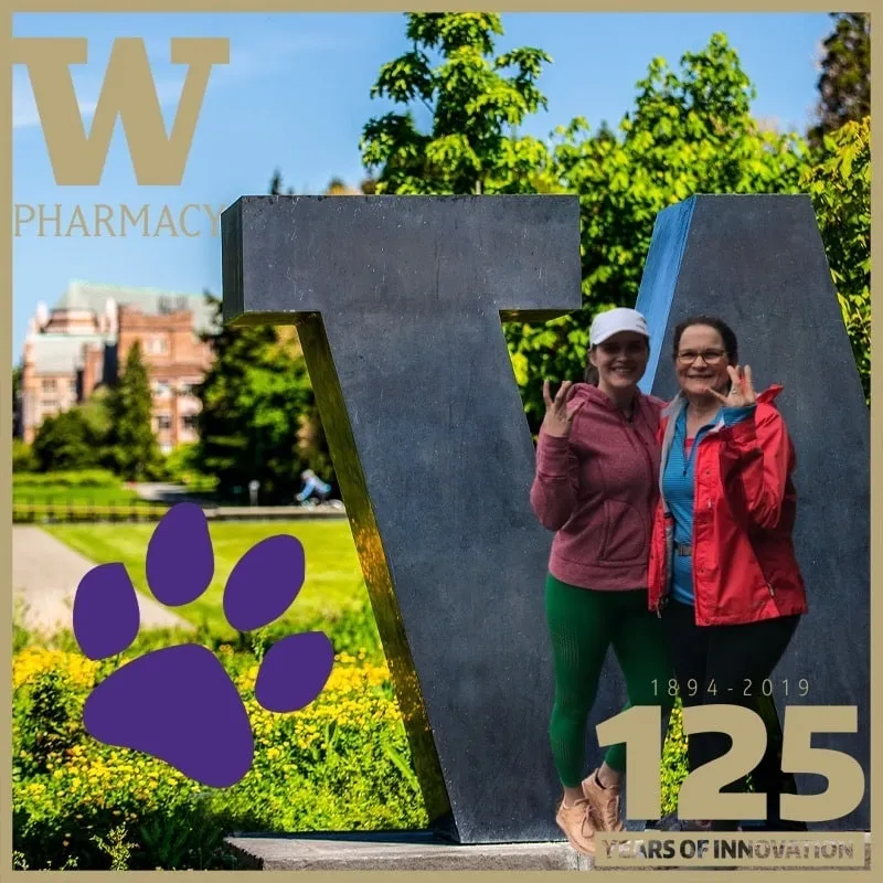 Photo booth snapshot of two guests at the W statue on a UW Pharmacy 125 years of innovation frame