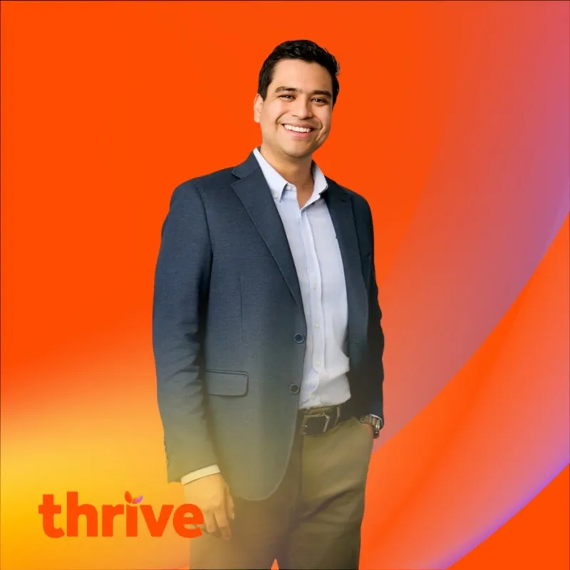 Photo booth snapshot of a guest in a blazer on an orange Thrive frame