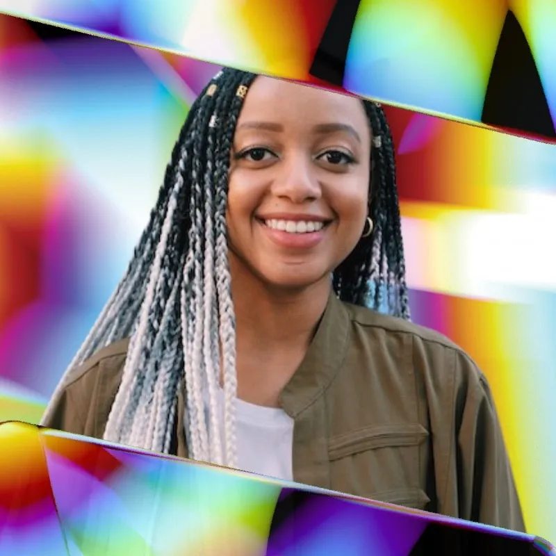 Photo booth snapshot of a guest with braids framed by rainbow prism reflections