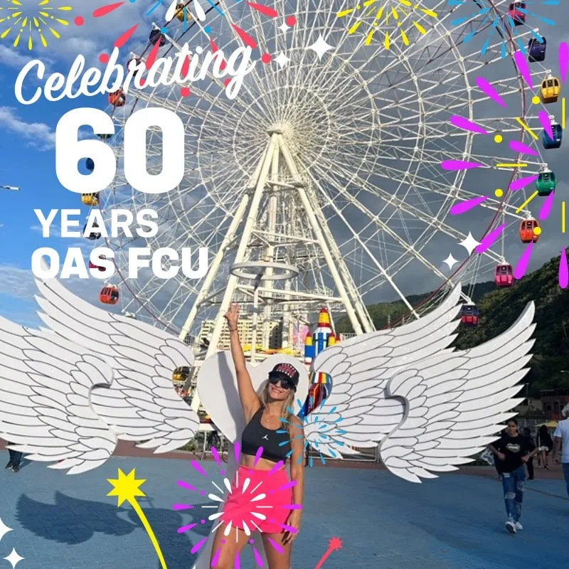 Photo booth snapshot of a guest with angel wings before a ferris wheel on an OAS FCU 60 years frame