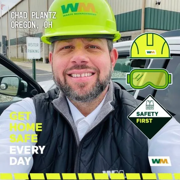 Photo booth snapshot of a WM worker in a green hard hat on a Get Home Safe Every Day safety frame