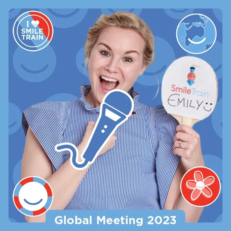 Photo booth snapshot of a guest with a paddle and microphone sticker on a Smile Train Global Meeting 2023 frame