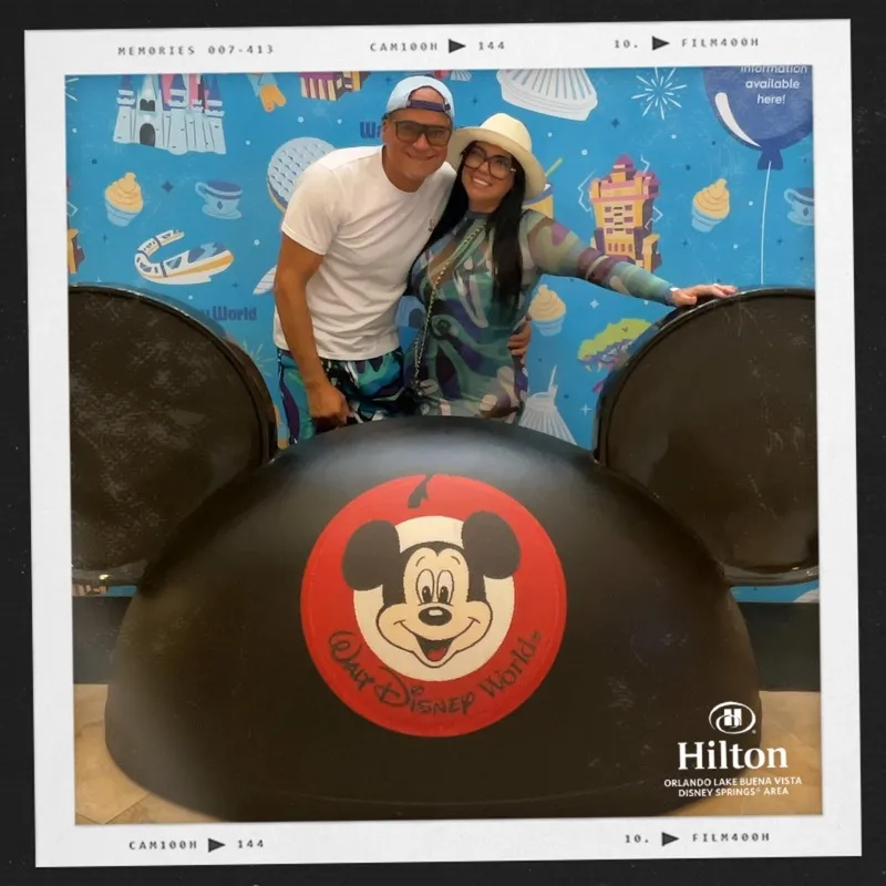 Photo booth snapshot of a couple behind giant Mickey ears on a Hilton Orlando film frame