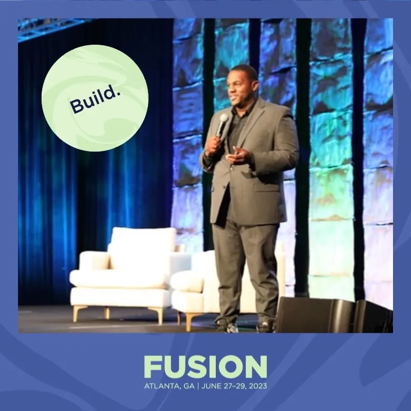Photo booth snapshot of a speaker on stage on a Fusion Atlanta Build frame