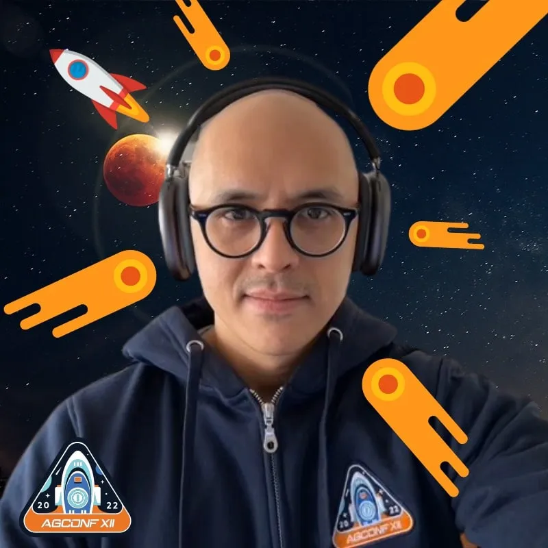 Photo booth snapshot of a guest in headphones on an AGConf XII space frame with comet stickers